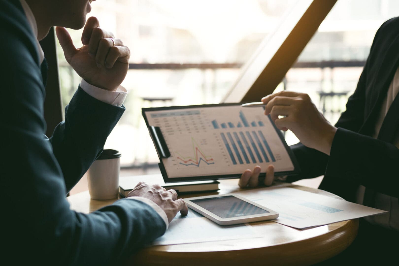 Businessmen reviewing financial charts and graphs.